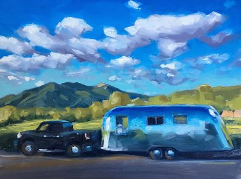 vintage airstream trailer with black ford truck with a view of Taos mountain