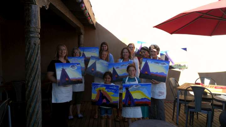 Painting class students display their sunset teepee paintings